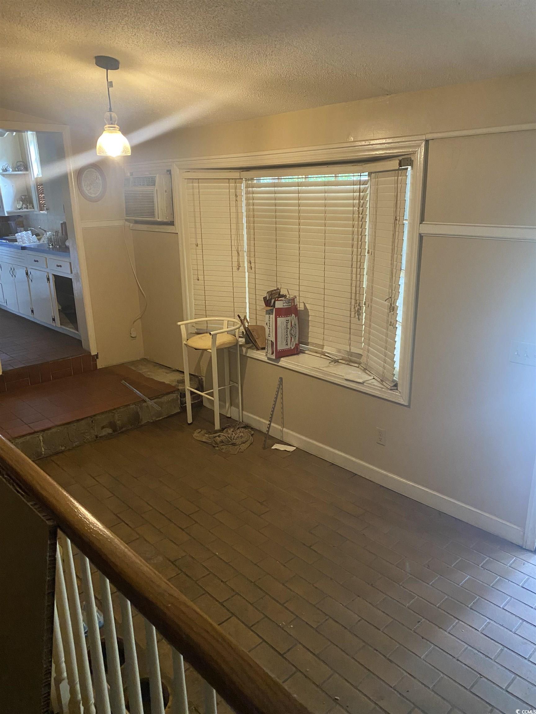 708 Grices Ferry Mullins, SC 29574 - Photo 5 of 13 Interior space with an AC wall unit and a textured ceiling