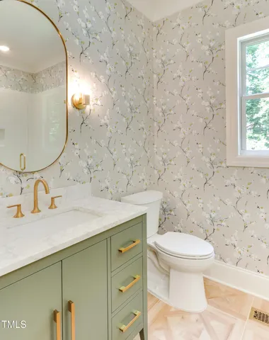 a bathroom with a sink toilet and mirror