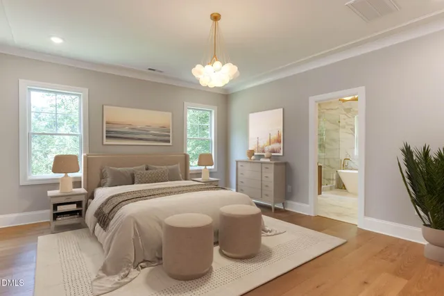 a bedroom with a bed and a chandelier