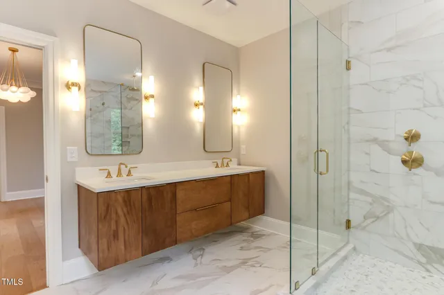a bathroom with a double vanity sink mirror and shower