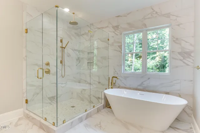 a bathroom with a bathtub and shower