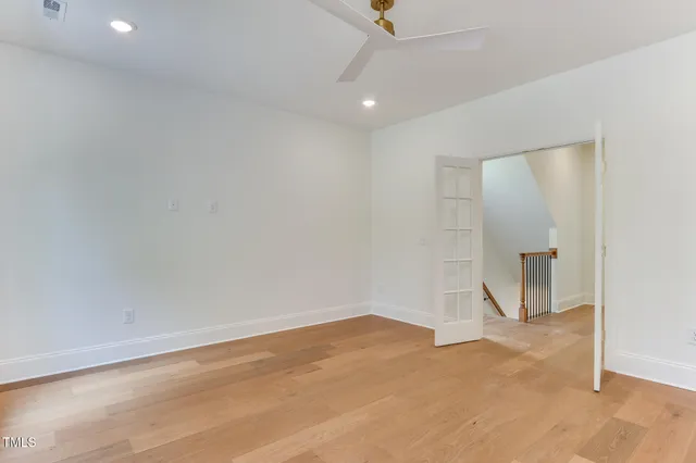 an empty room with closet and windows