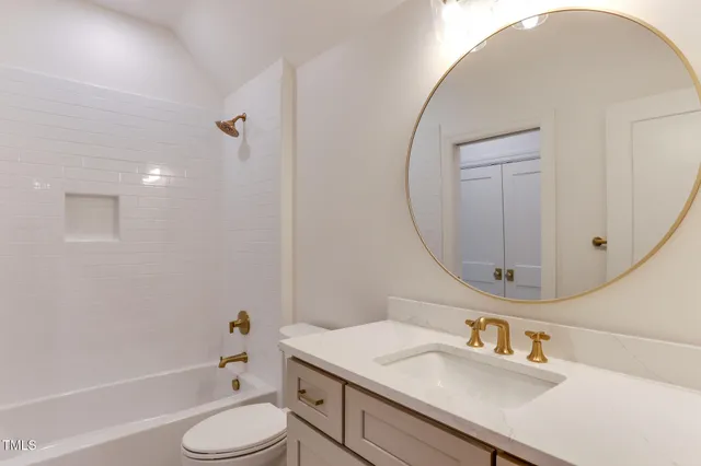 a bathroom with a sink toilet a tub and a mirror