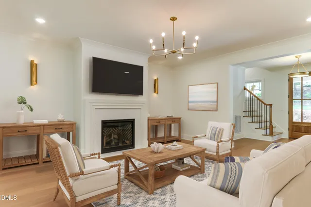 a living room with furniture a flat screen tv and a fireplace