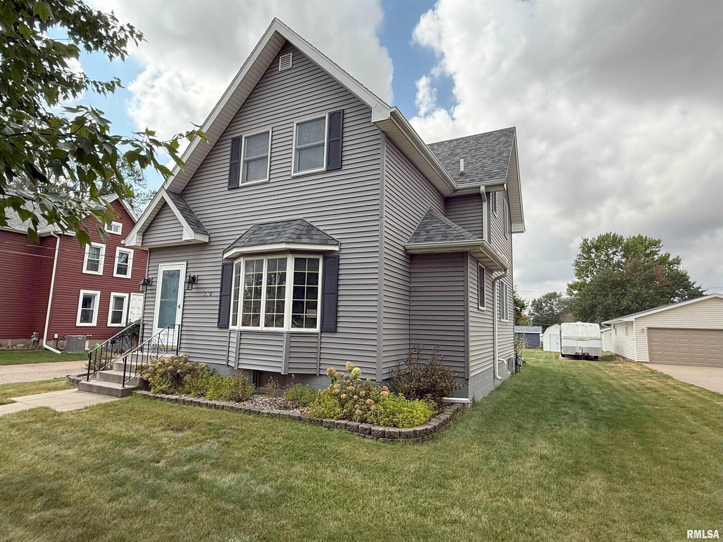 330 North Main Street Walcott, IA 52773 - Photo 3 of 39 a front view of a house with a yard
