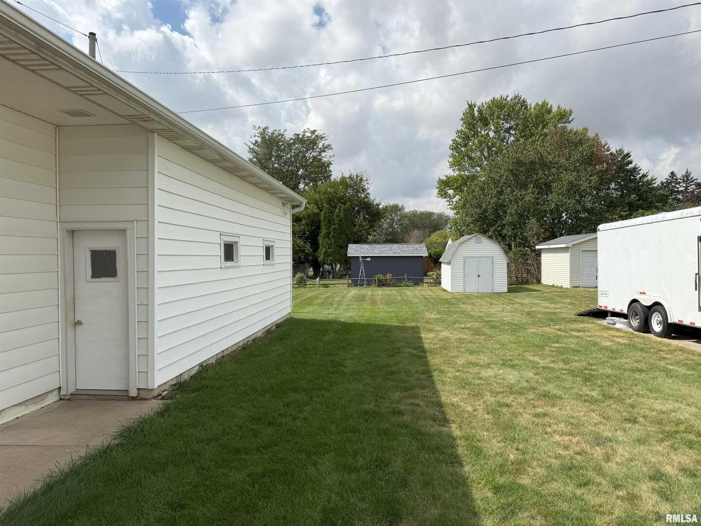330 North Main Street Walcott, IA 52773 - Photo 34 of 39 a view of a backyard with table and chairs and a barbeque