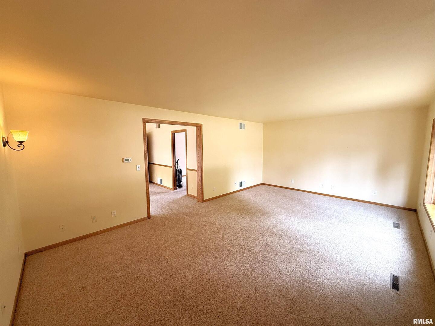 330 North Main Street Walcott, IA 52773 - Photo 6 of 39 an empty room with a empty space and windows