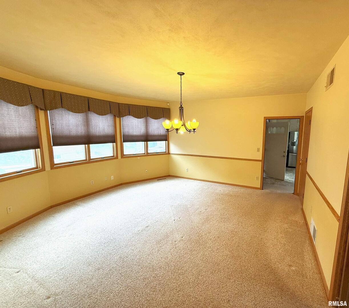 330 North Main Street Walcott, IA 52773 - Photo 7 of 39 a view of an empty room with a window