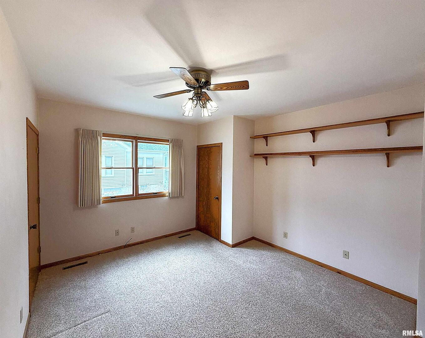 330 North Main Street Walcott, IA 52773 - Photo 9 of 39 a view of a livingroom with a ceiling fan and window