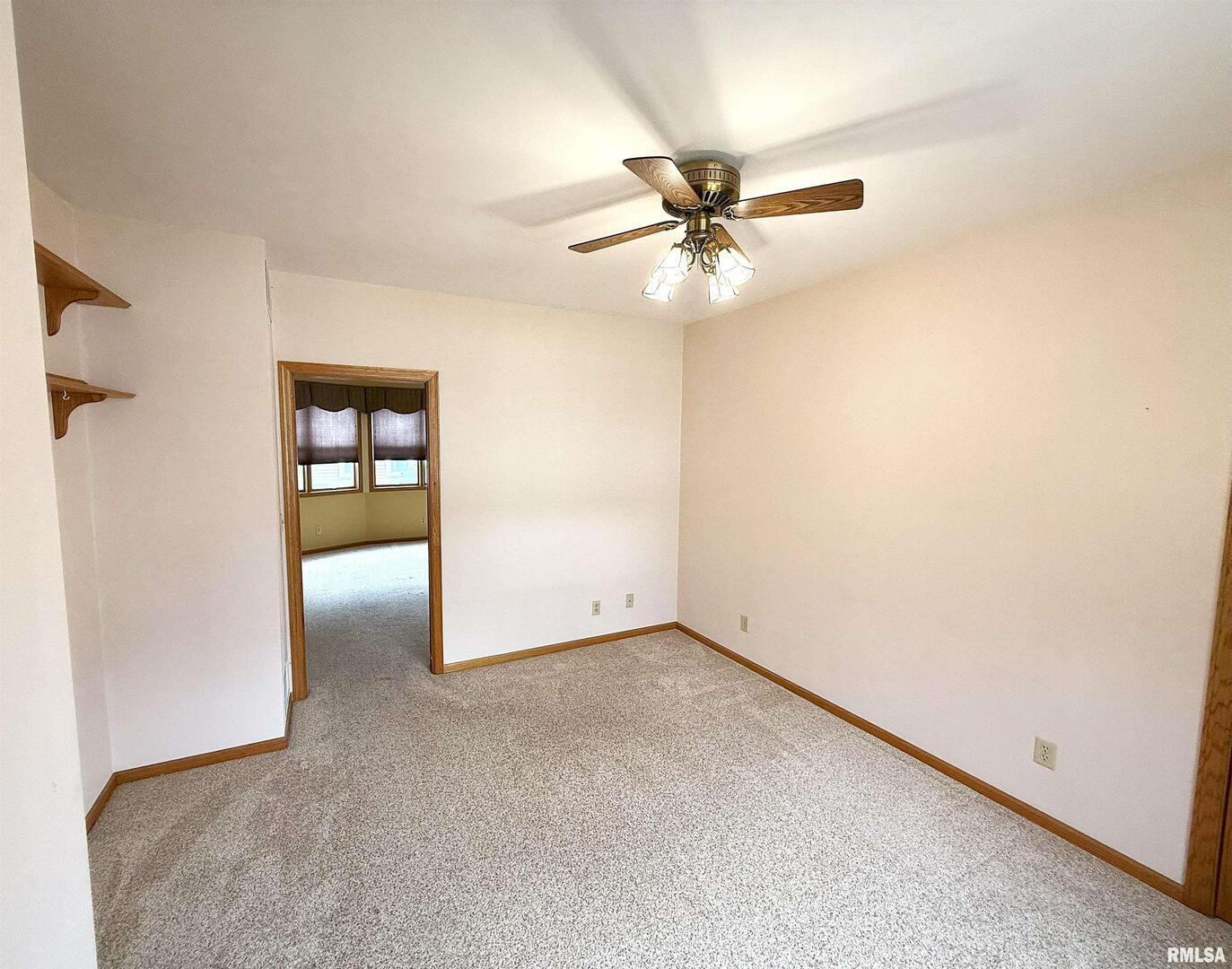 330 North Main Street Walcott, IA 52773 - Photo 10 of 39 an empty room with closet and fan