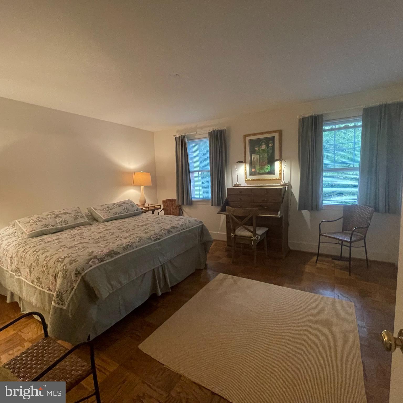 3221 Sutton Place Northwest, Unit B Washington, DC 20016 - Photo 13 of 22 a spacious bedroom with a bed a table and chair