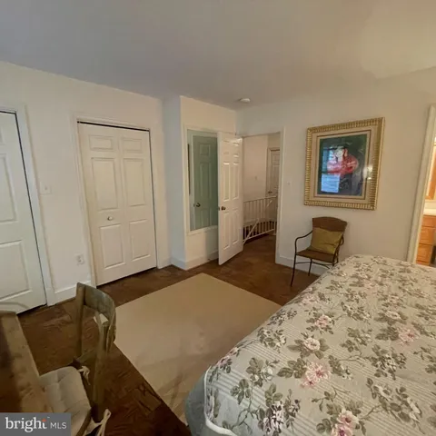 a bedroom with a bed and a couch