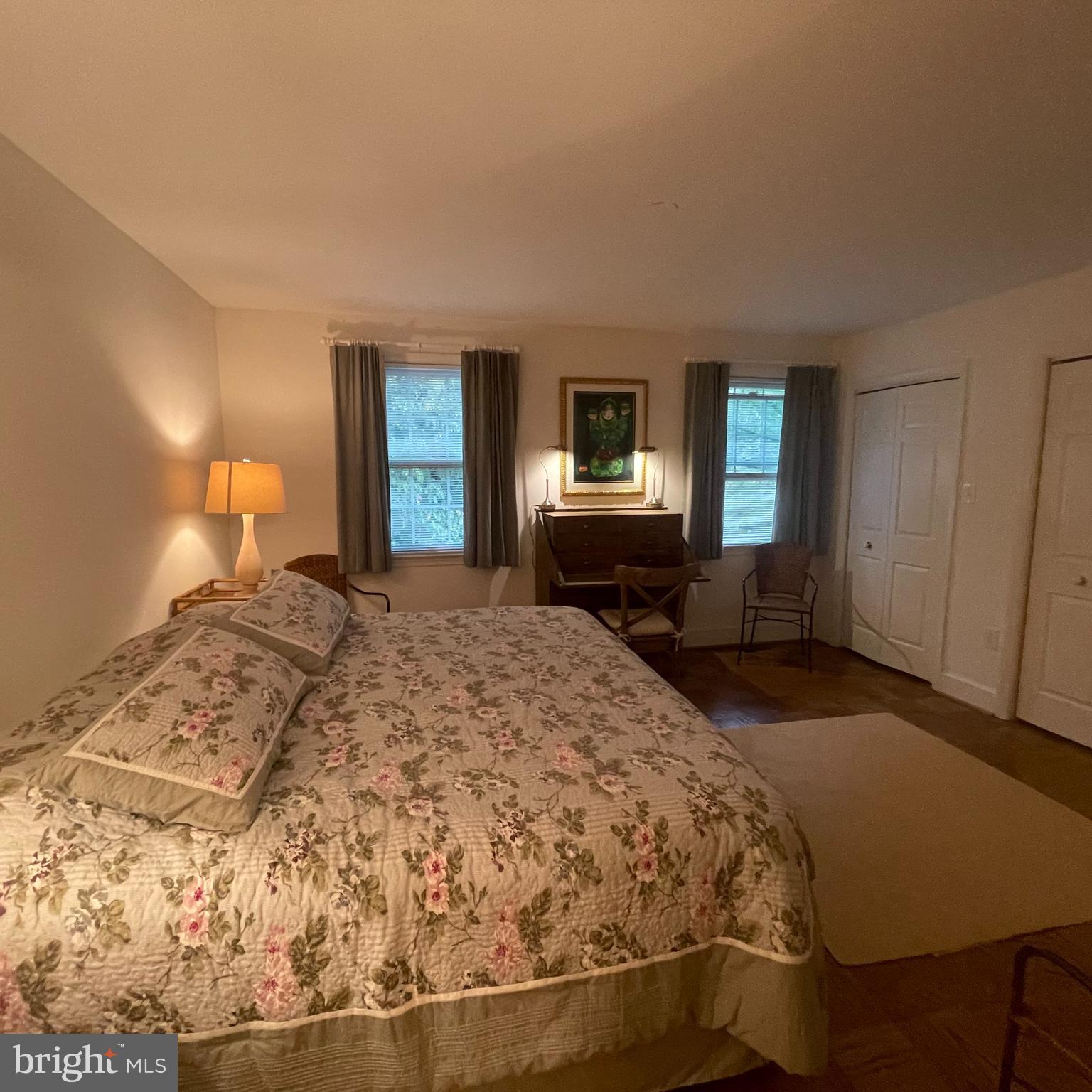 3221 Sutton Place Northwest, Unit B Washington, DC 20016 - Photo 16 of 22 a bedroom with a bed and wooden floor