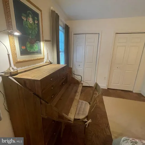 a living room with a bed and large window