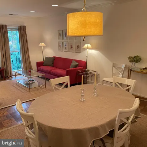 a dining room with furniture and window
