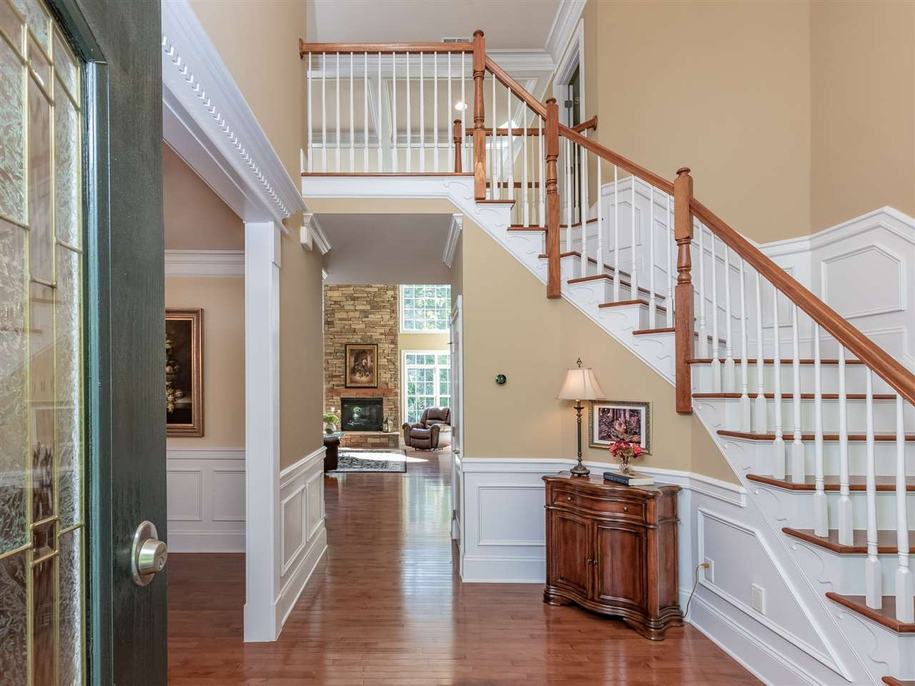 4717 Haleytree Court Raleigh, NC 27606 - Photo 3 of 30 Enter into a 2 story elegant foyer with curved staircase, heavy trim throughout the home, upgraded hardwoods! Entry