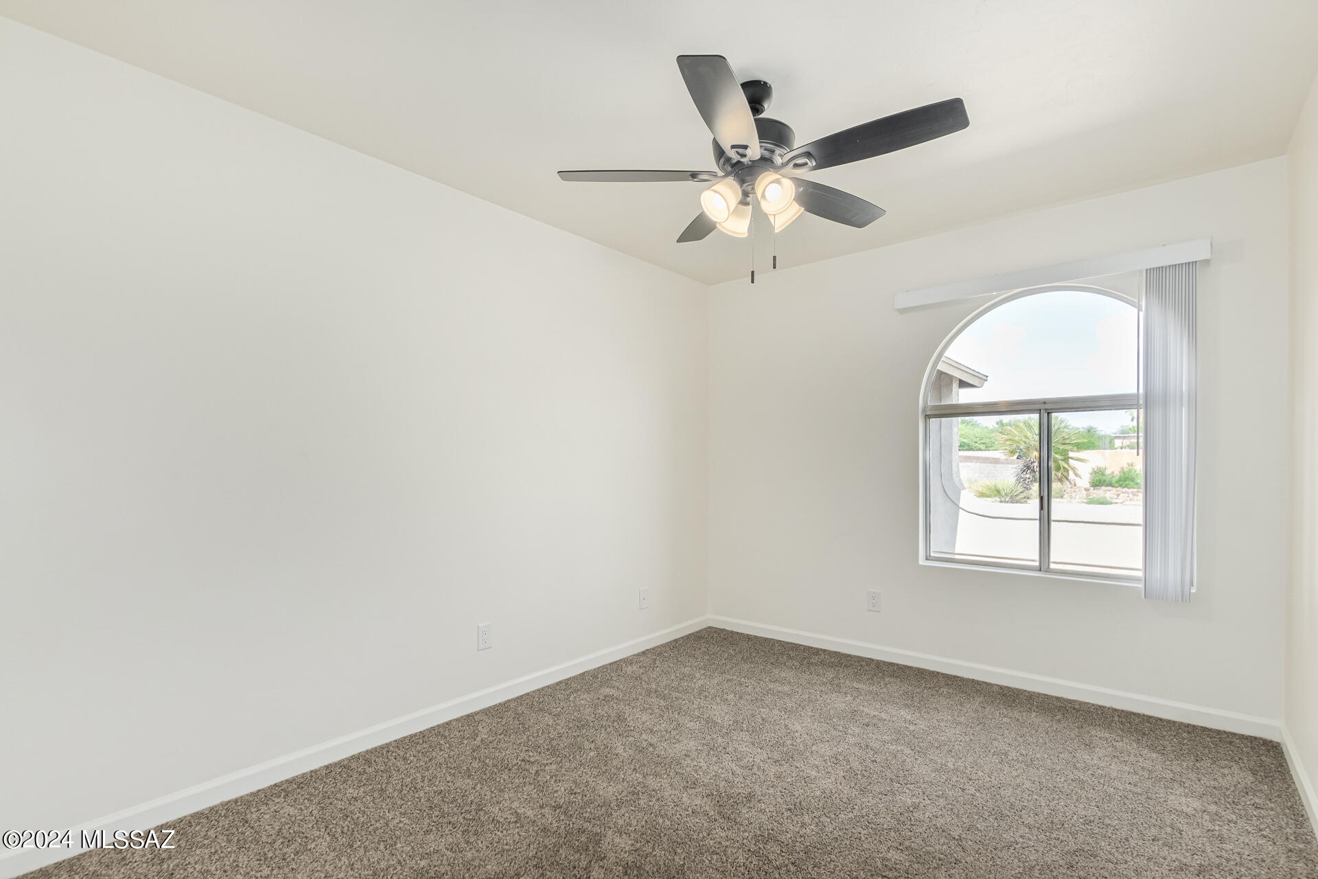 1454 South Gecko Road Tucson, AZ 85713 - Photo 16 of 24 an empty room with windows and fan