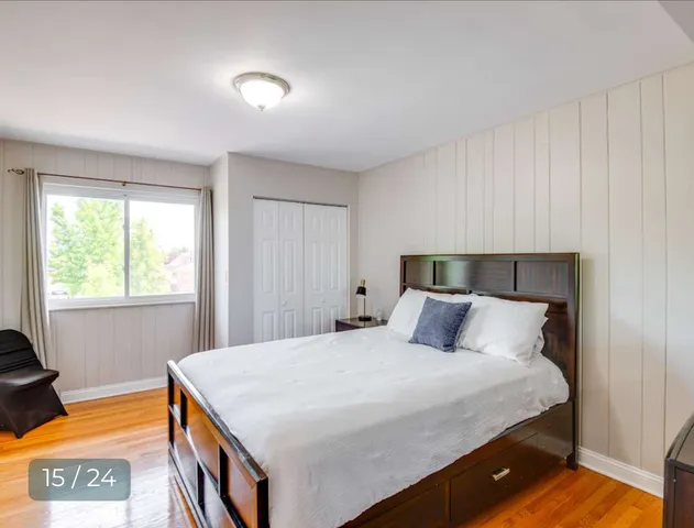 a bedroom with a large bed and dresser