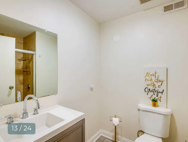 a bedroom with a bed and dresser with mirror