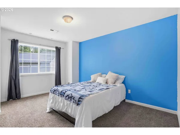 a bedroom with a bed and a window