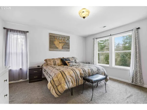 a bed room with a bed and a chair