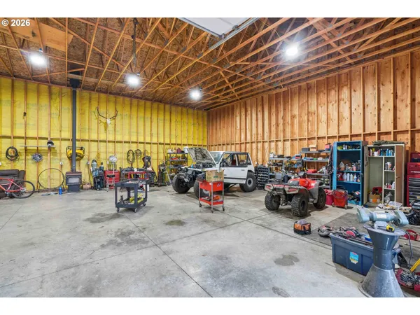 a view of a garage with cars and parked