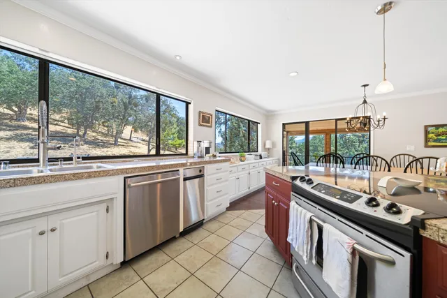 a kitchen that has a sink and a stove