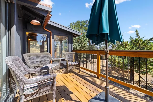 a view of balcony with furniture and a potted plant