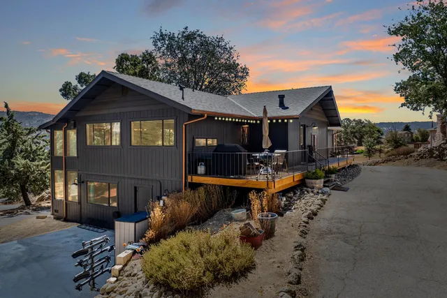 a front view of a house with swimming pool and sitting area