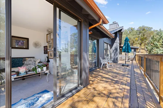 a view of a balcony with chairs and potted plants