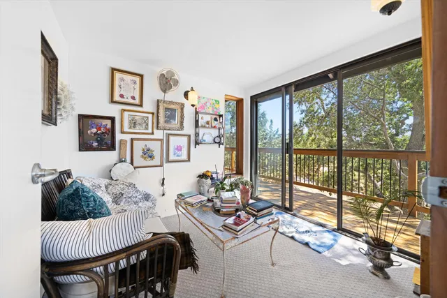 a living room with furniture and a floor to ceiling window
