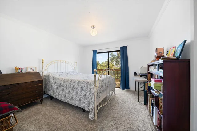a bedroom with a bed and a book shelf