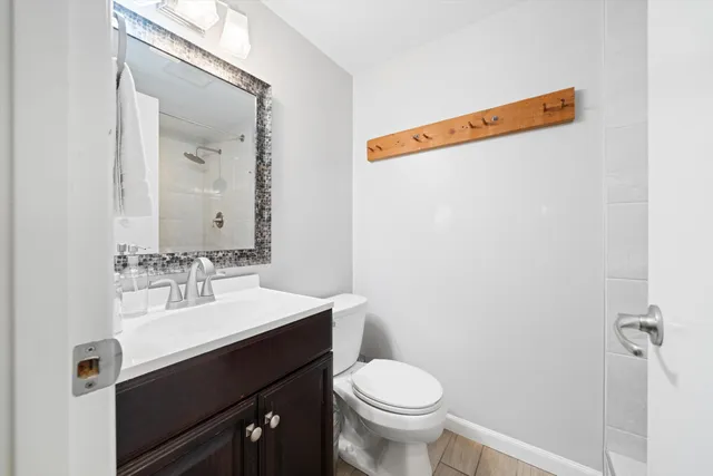 a bathroom with a sink vanity and toilet