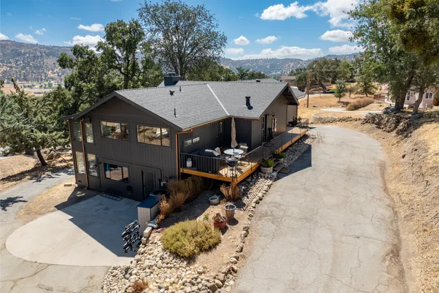 a view of a house with a yard covered with snow in the background