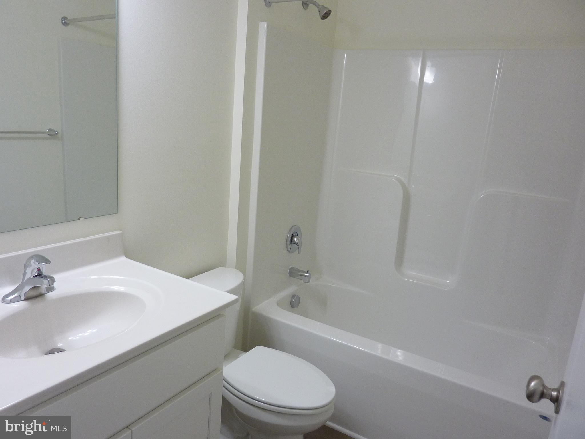 175 Villa Drive Clayton, DE 19938 - Photo 30 of 44 a bathroom with a sink a toilet and shower