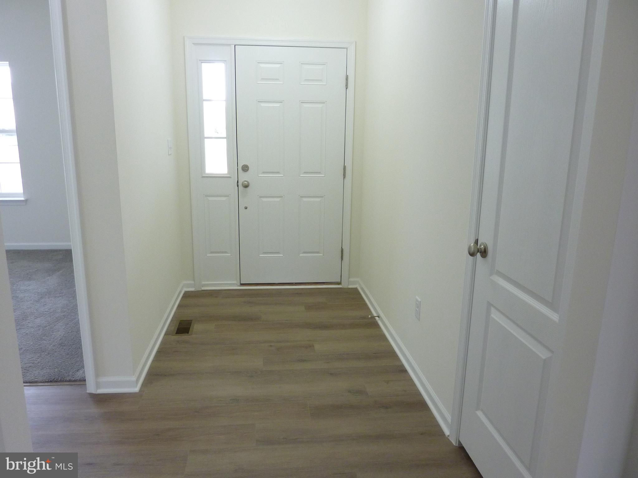 175 Villa Drive Clayton, DE 19938 - Photo 4 of 44 a view of a hallway with wooden floor