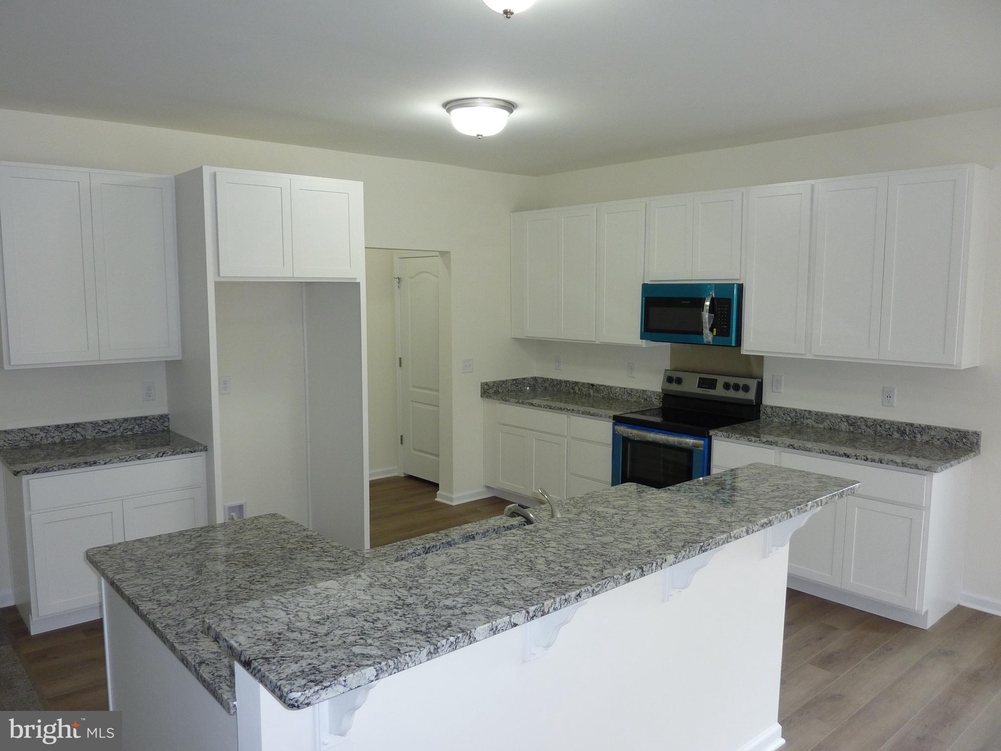 175 Villa Drive Clayton, DE 19938 - Photo 10 of 44 a kitchen with stainless steel appliances granite countertop a sink stove and refrigerator