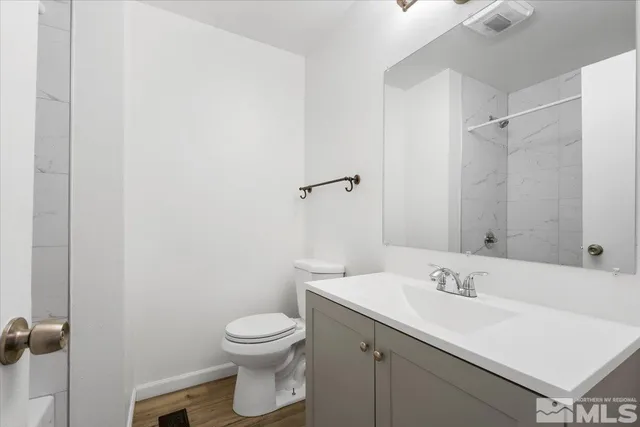 a bathroom with a sink toilet and vanity