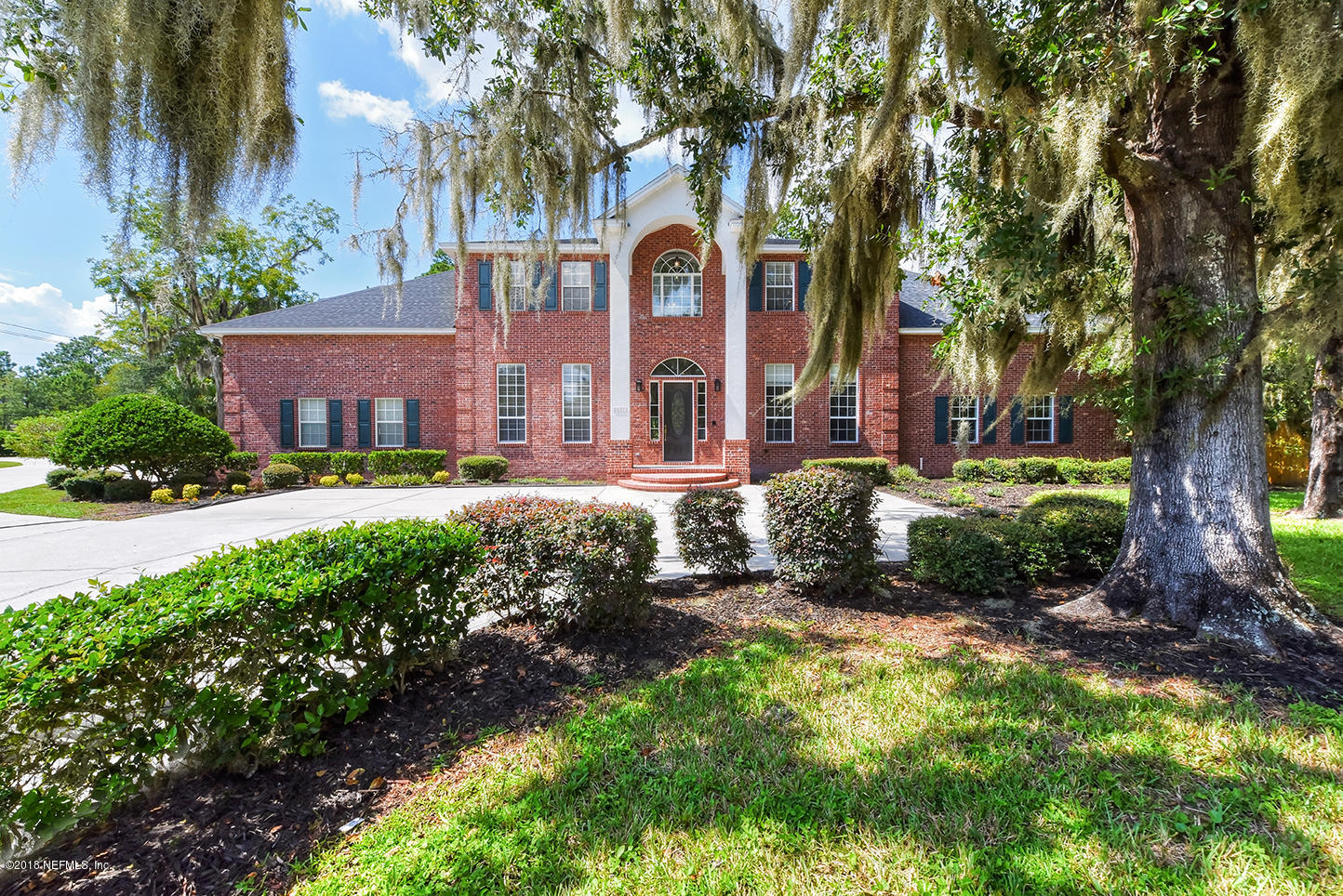 14511 Mandarin Road Jacksonville, FL 32223 - Photo 1 of 91 a front view of a house with a yard and large trees
