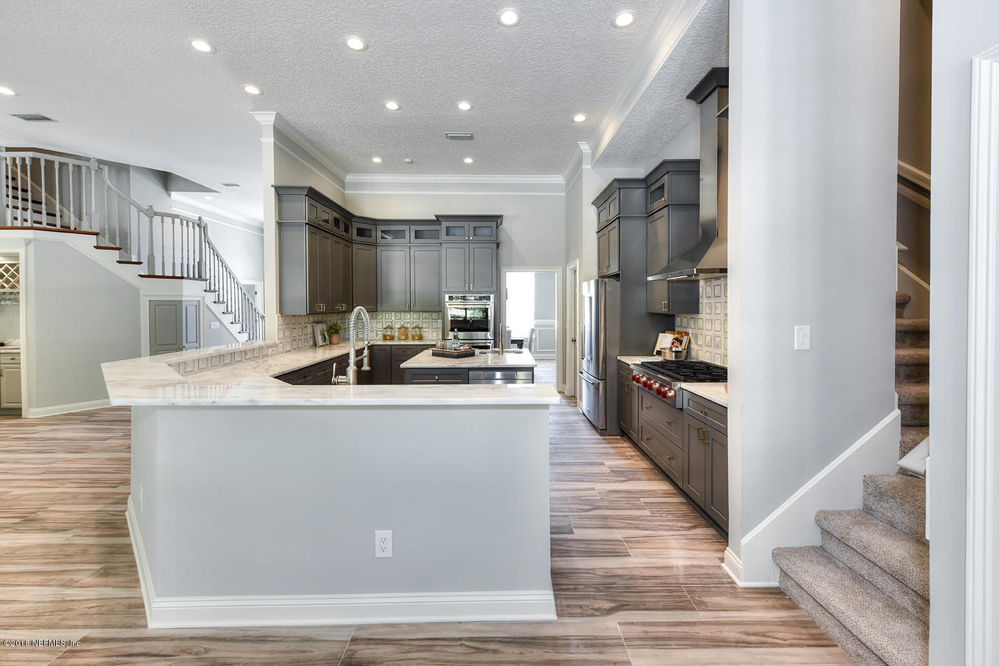 14511 Mandarin Road Jacksonville, FL 32223 - Photo 31 of 91 a large white kitchen with kitchen island a stove a sink a refrigerator and cabinets