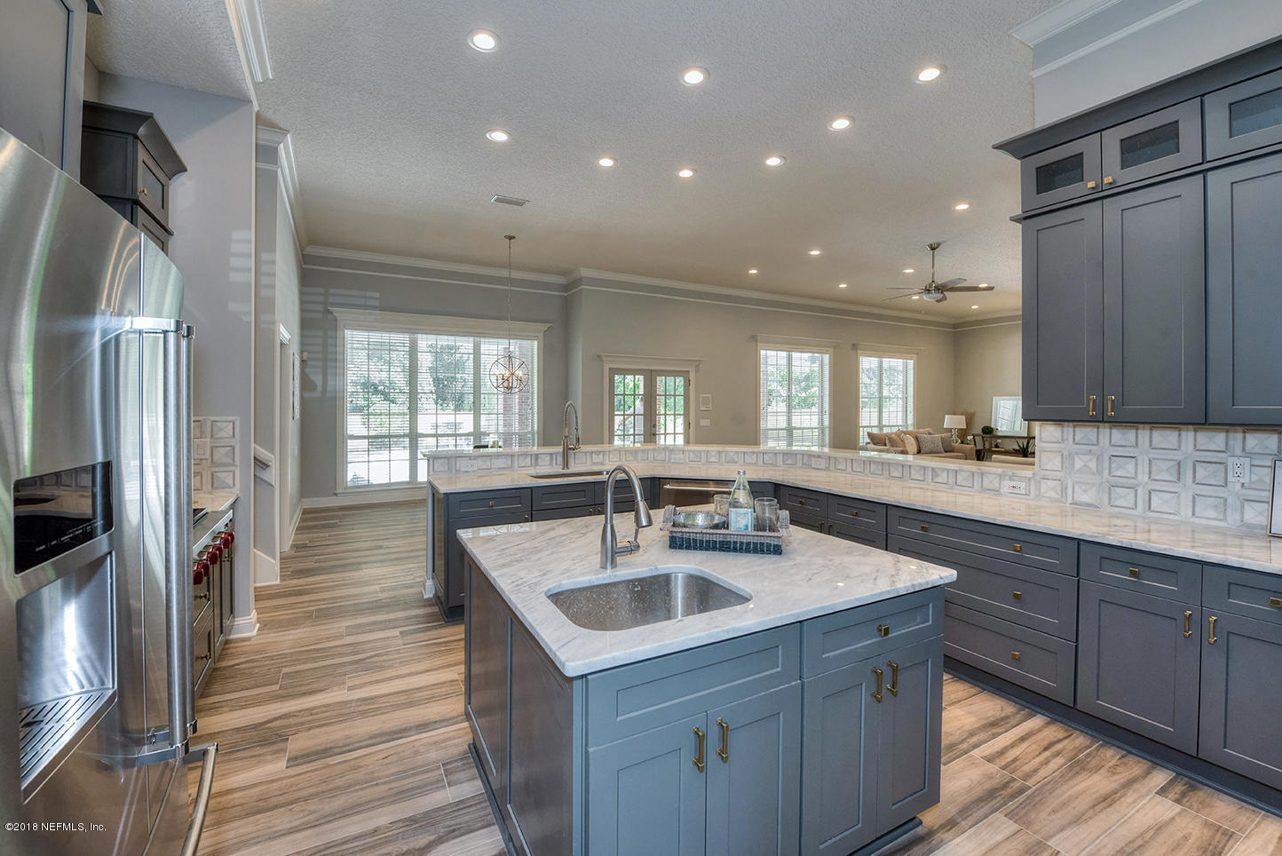14511 Mandarin Road Jacksonville, FL 32223 - Photo 33 of 91 a kitchen with center island wooden floor and stainless steel appliances