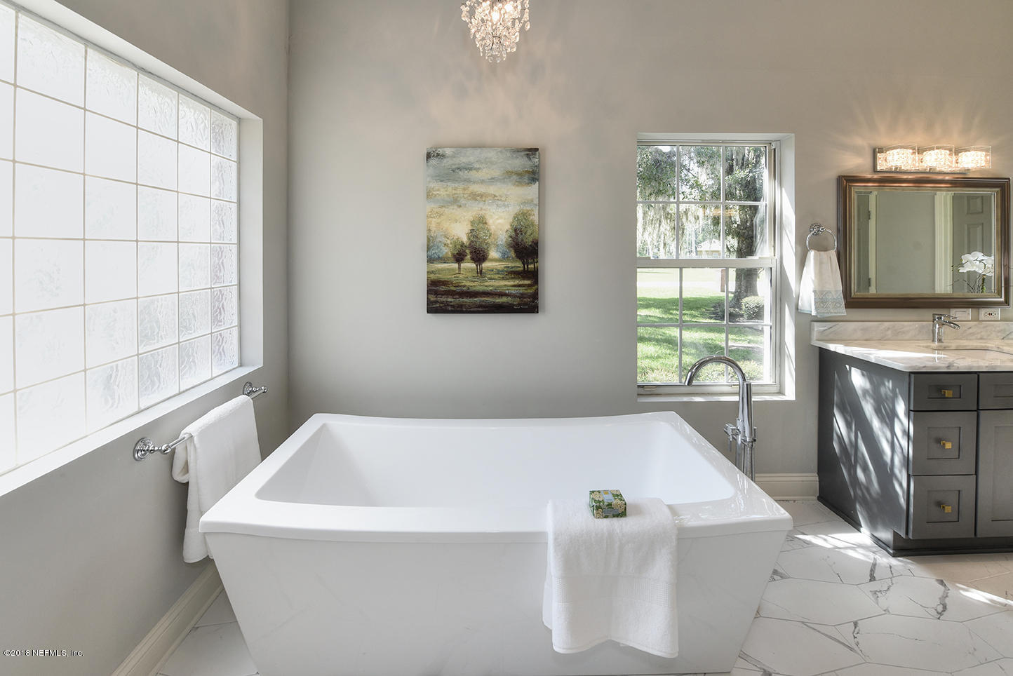 14511 Mandarin Road Jacksonville, FL 32223 - Photo 49 of 91 a white bath tub sitting in a en suite bathroom next to a window