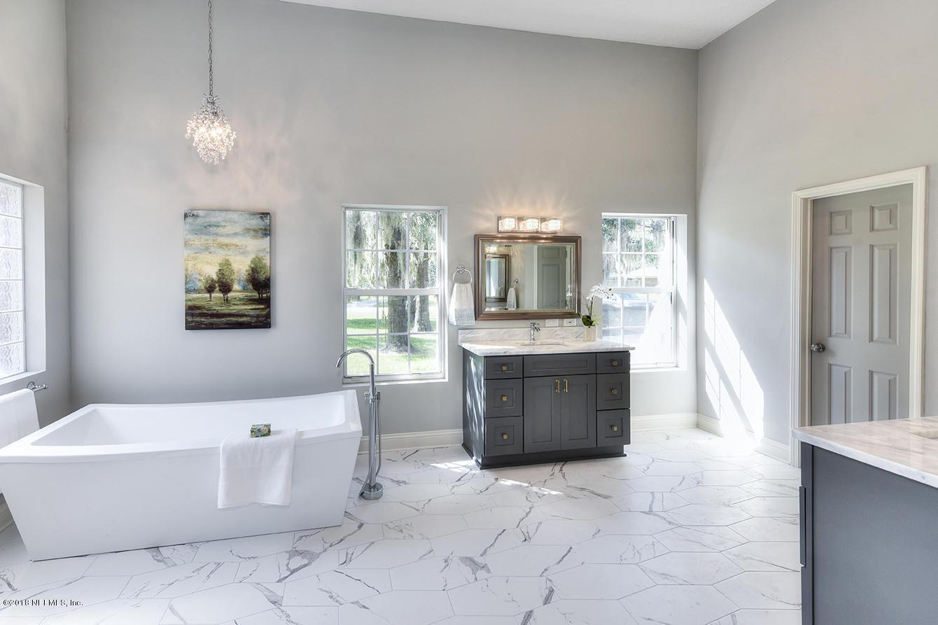 14511 Mandarin Road Jacksonville, FL 32223 - Photo 50 of 91 a large spacious bathroom with a tub sink and mirror