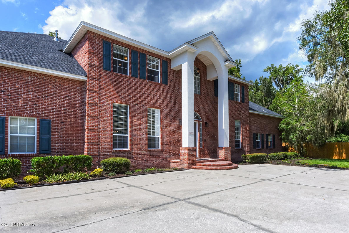14511 Mandarin Road Jacksonville, FL 32223 - Photo 5 of 91 front view of a brick house with a yard