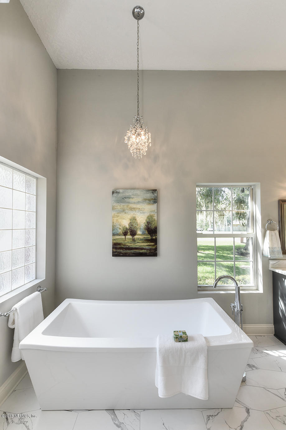 14511 Mandarin Road Jacksonville, FL 32223 - Photo 51 of 91 a white bath tub sitting in a bathroom next to a window