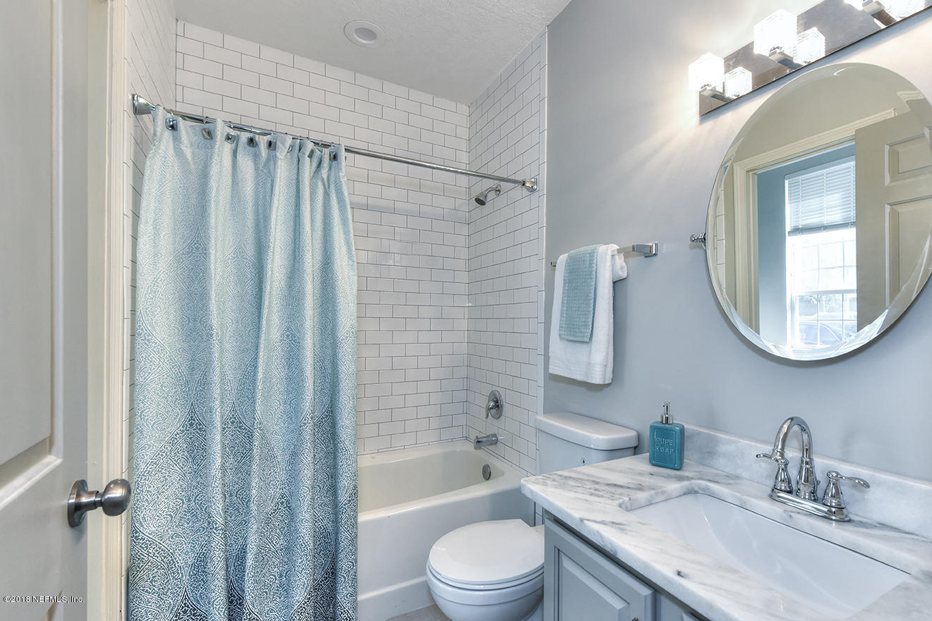 14511 Mandarin Road Jacksonville, FL 32223 - Photo 70 of 91 a bathroom with a granite countertop sink toilet a mirror a vanity and shower