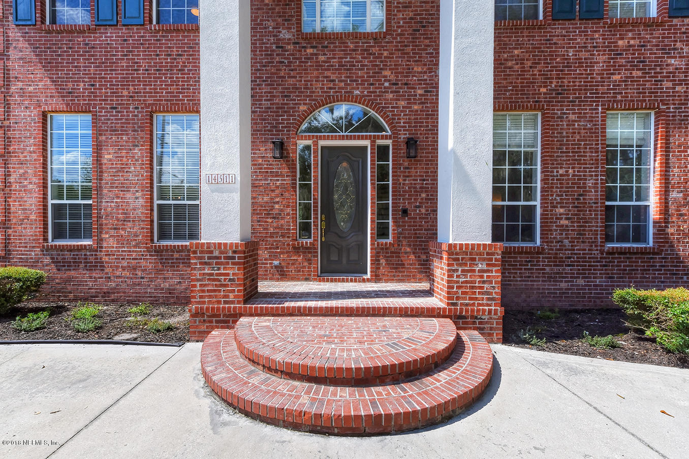 14511 Mandarin Road Jacksonville, FL 32223 - Photo 7 of 91 a view of a brick house with a large windows