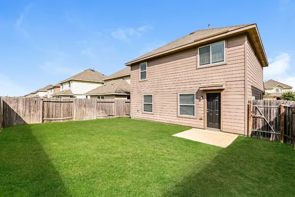 a view of a house with a yard and porch