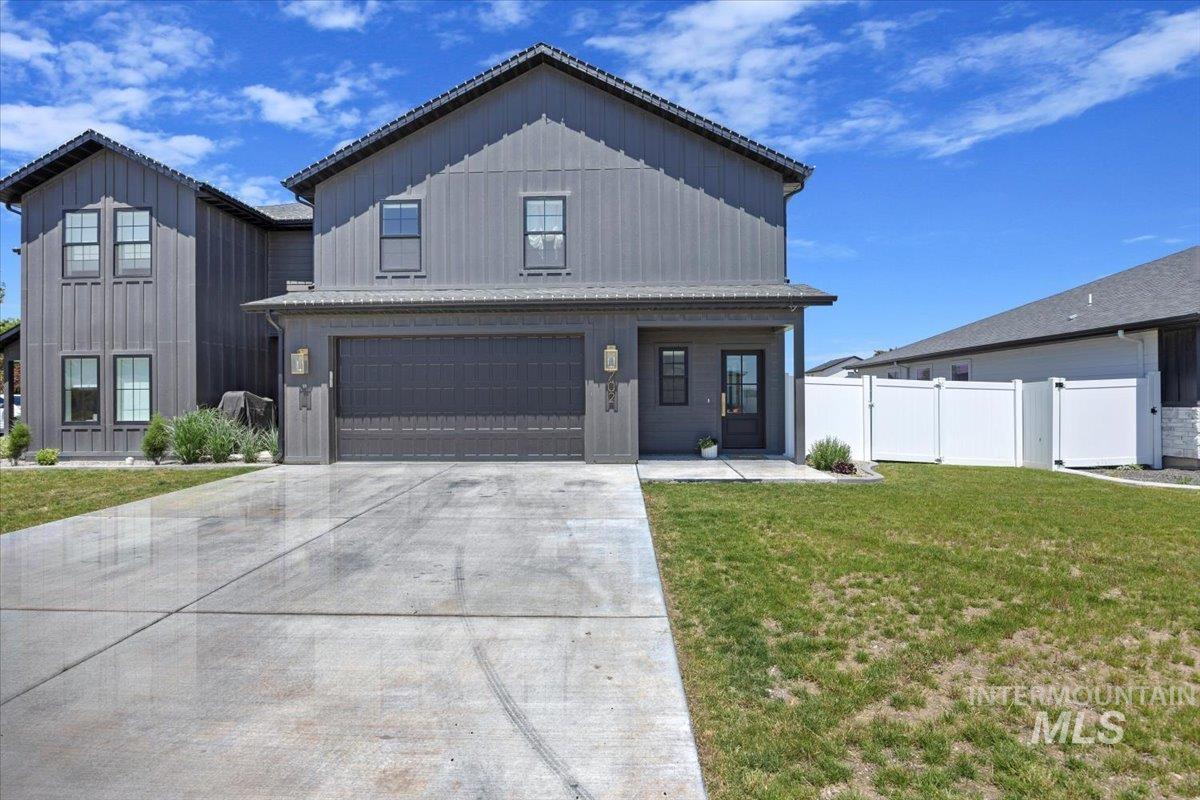 702 Lake Street Kimberly, ID 83341 - Photo 1 of 1 Modern inspired farmhouse with an attached garage, driveway, and board and batten siding