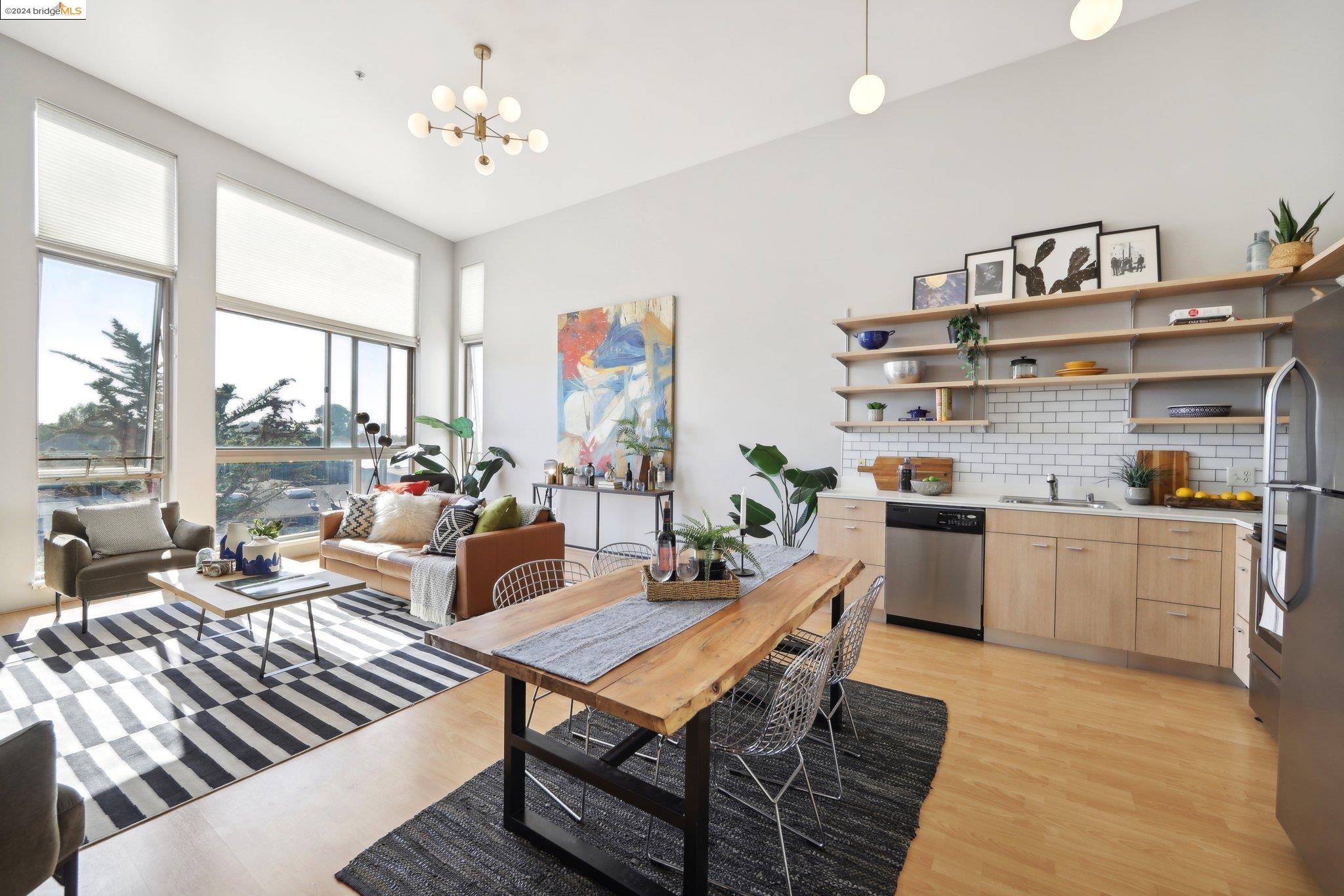 1201 Pine Street, Unit 462 Oakland, CA 94607 - Photo 1 of 1 a living room with granite countertop furniture a rug and a floor to ceiling window